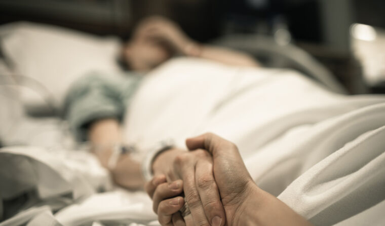 Patient lying in hospital bed.