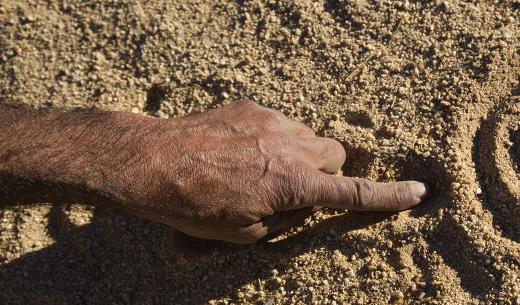 Indigenous Australian hand drawing in the sand