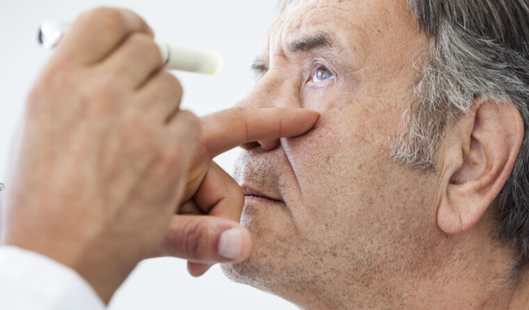 Doctor looking into someone's eye.
