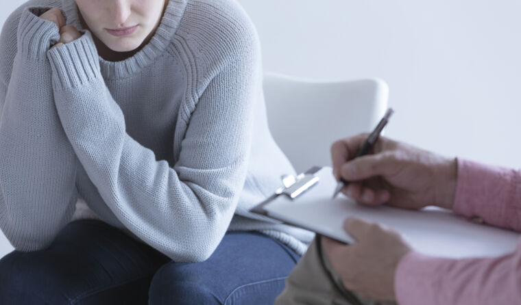 A person sitting down with a health professional.