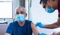 Aged care resident receiving COVID vaccination