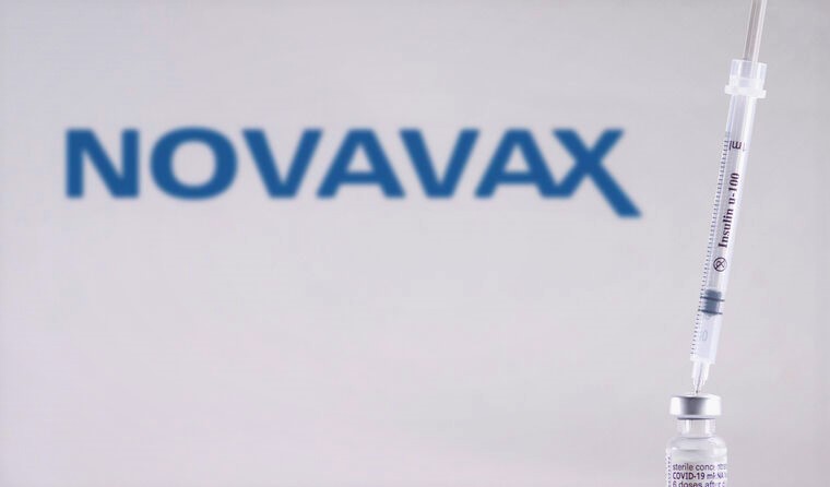 A syringe in a vial of Novavax’s COVID-19 vaccine.