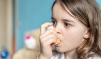 Child using asthma puffer