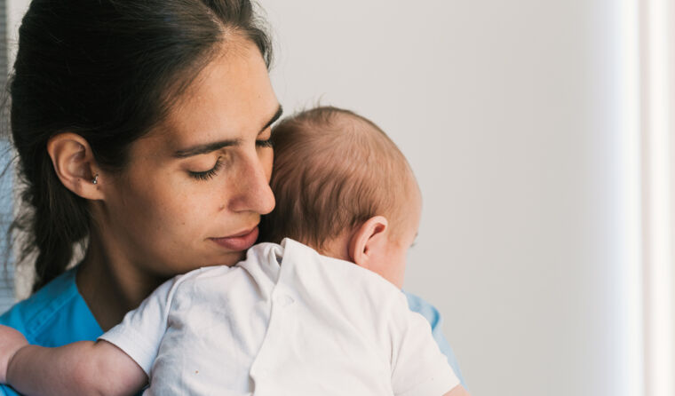 Woman holding a baby.