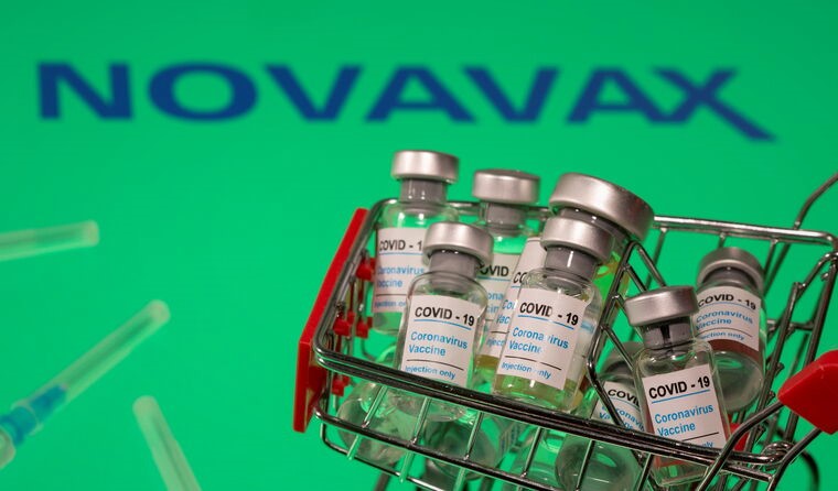 Shopping cart holding Novavax vaccine vials.