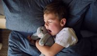 A tired child yawning.