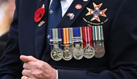 Older man with military medals on blazer.