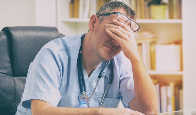 A doctor looking stressed