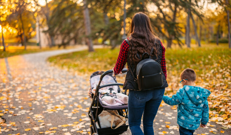 A mother and young child walking