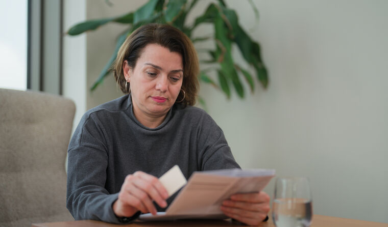 Middle-aged woman reading medication information