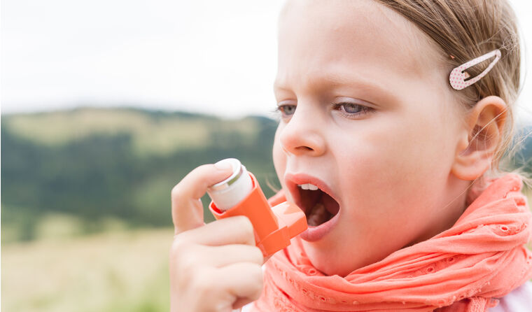 Child taking asthma puffer