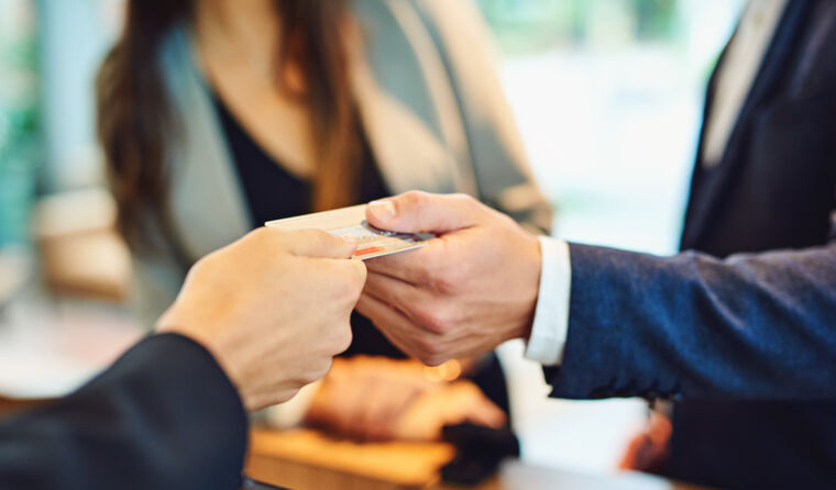 Person paying with card at reception.