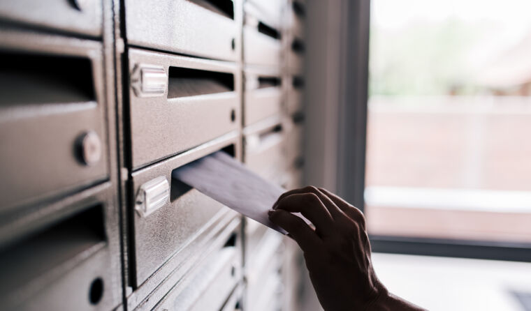 Checking letter in mailbox.