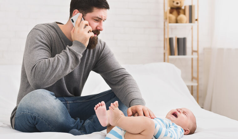 Man on phone with baby