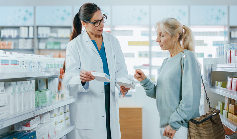 Pharmacist offering customer 2 types of medication