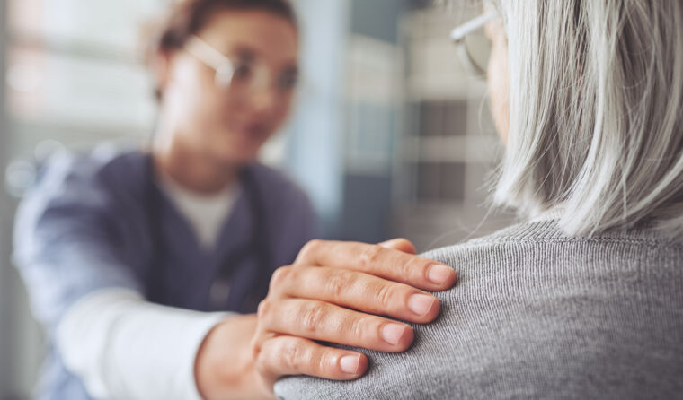 Doctor touching a patient's shoulder. 