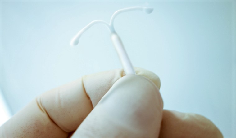 Doctor holding an intrauterine device