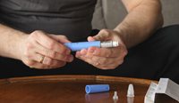 A patient prepares an injection of semaglutide