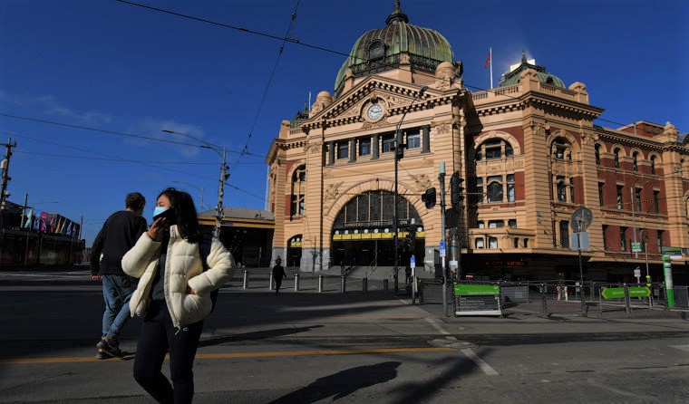 Woman in mask at Flinders Station