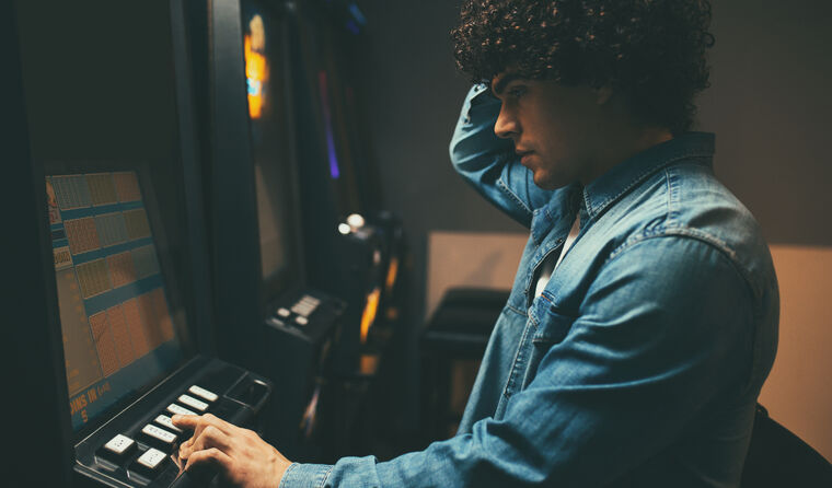 Man gambling at slot machine