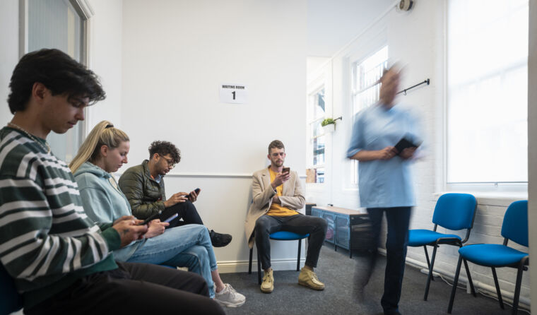 Patients waiting in a doctors' waiting room. 