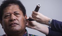 Indigenous man getting a hearing test.