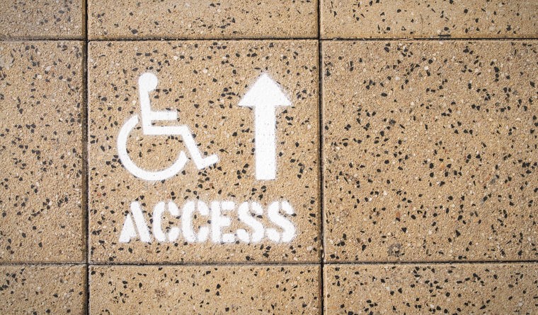 Wheelchair access sign on the footpath.