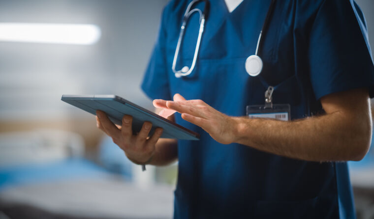 GP looking at tablet.