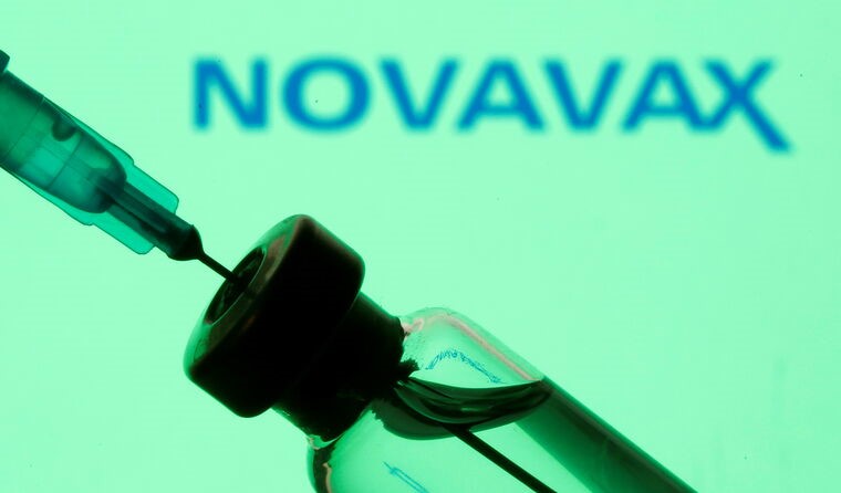 Doctor drawing Novavax vaccine from vial.