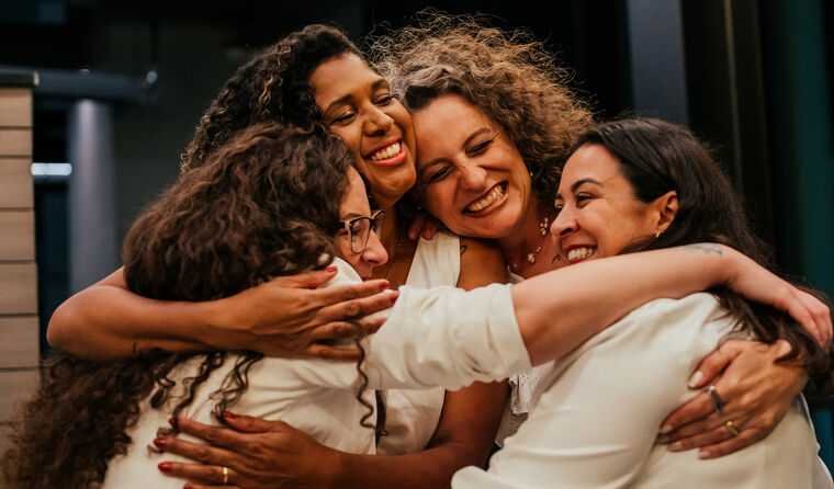 Group of happy women hugging