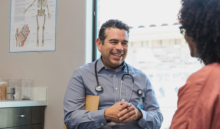 Male GP smiling with patient