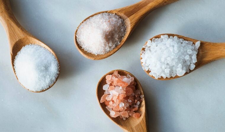 Spoons of white and pink salt 