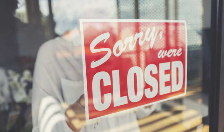 Closed sign in front window.