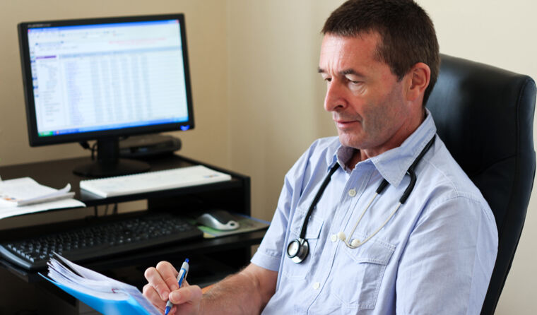Male GP doing paperwork