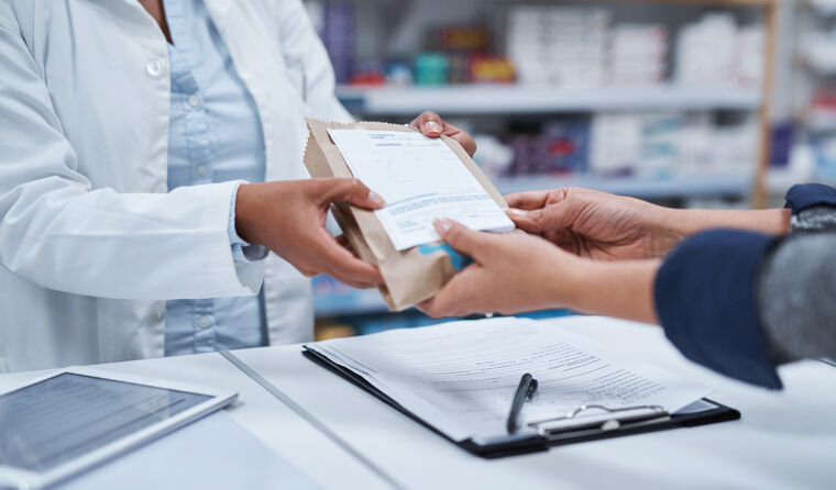 Pharmacist handing over prescription