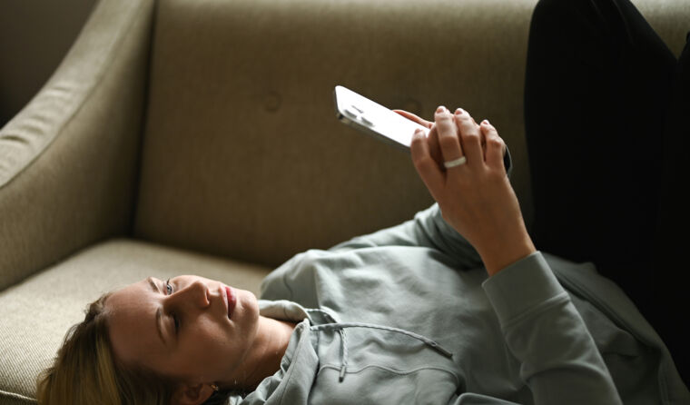 Woman scrolling on her phone.