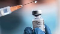 Doctor holding vial of Pfizer vaccine.