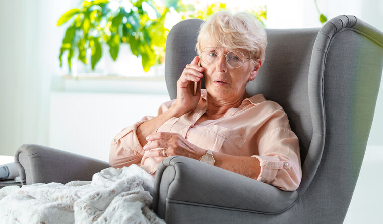 An elderly woman on the phone. 