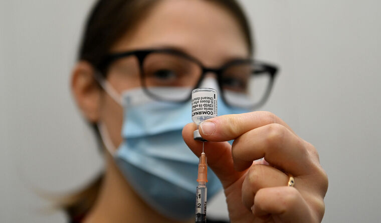 Nurse administering Pfizer vaccine