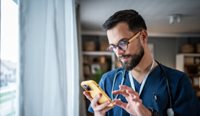 Doctor looking at his phone.