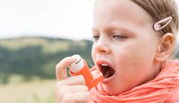 Child taking asthma puffer