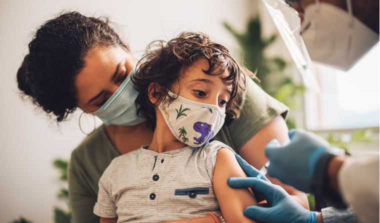 A child receiving a COVID-19 vaccine.