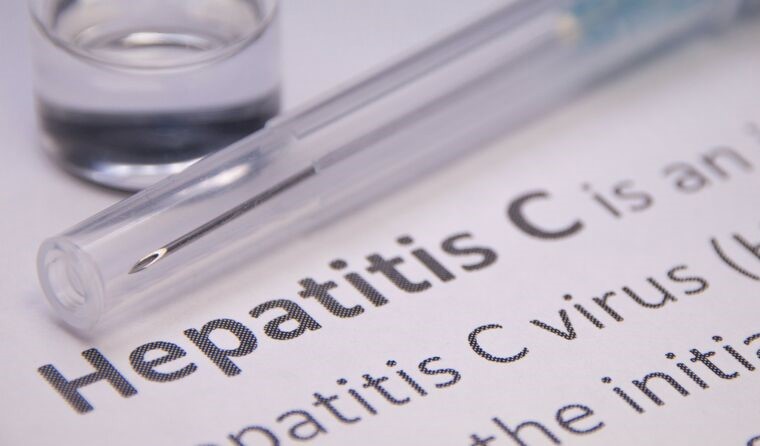 Close up of needle and hepatitis C definition