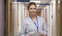 Young, female GP in hospital corridor