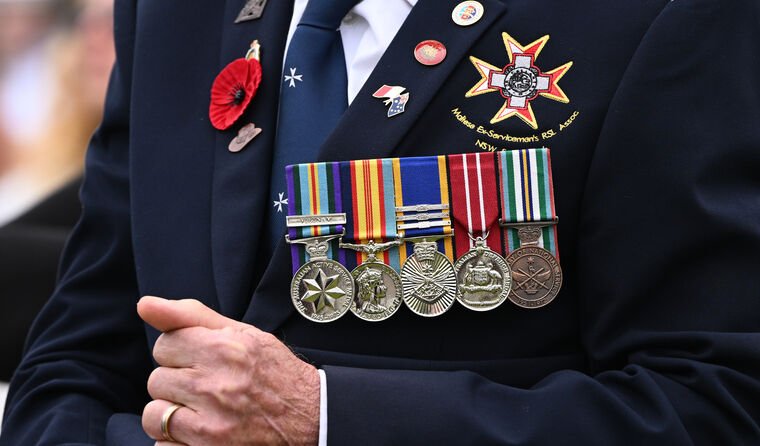 Older man with military medals on blazer.