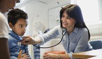 GP using stethoscope on young child.