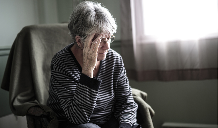 A senior woman at home feeling worried.
