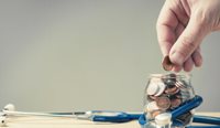 Coin going into a jar surrounded by stethoscope