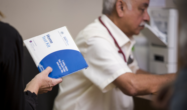 A patient holding a NPCSP kit.