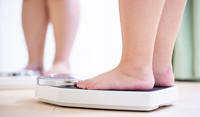 An overweight woman's feet on weighing scales.